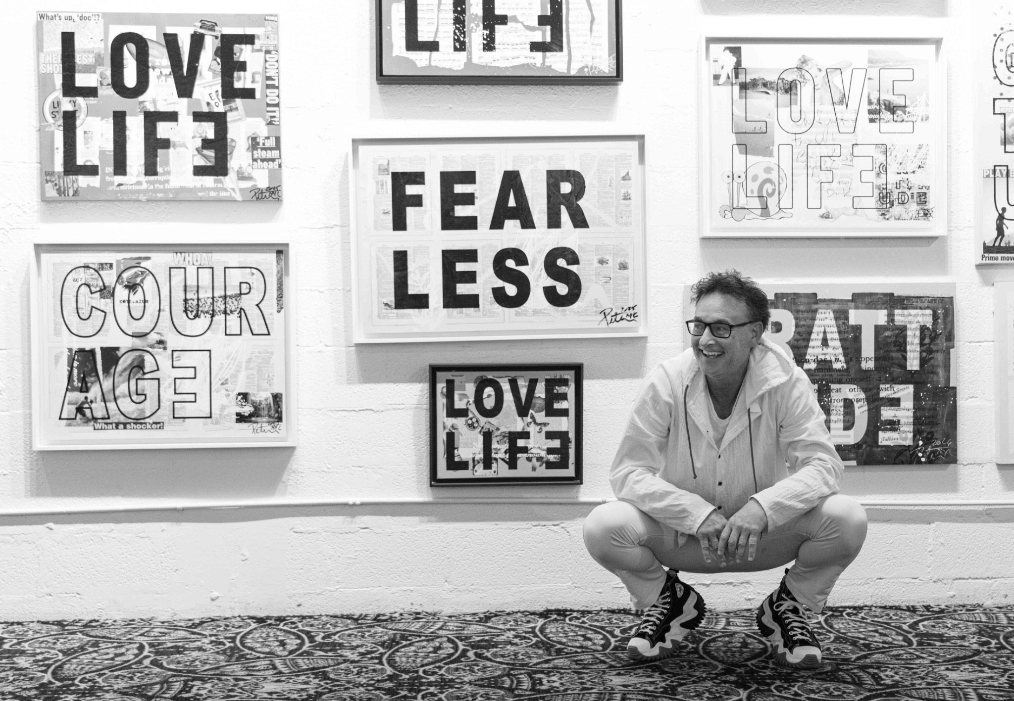 Adam Greenfader surrounded by Love Life artwork