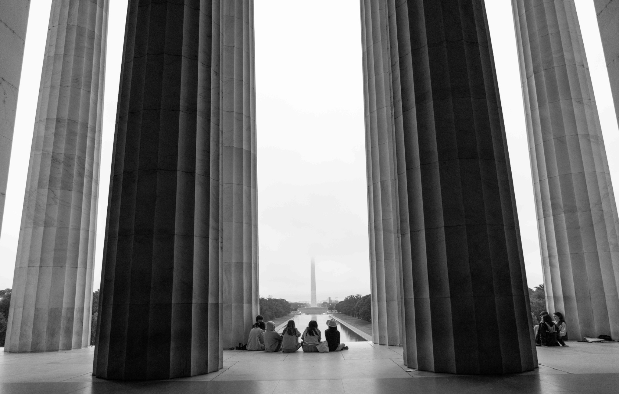 Visitors framed by the columns of the Lincoln Memorial